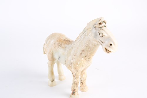 Lot 281 - A Chinese Han style white jade horse, Qing,...