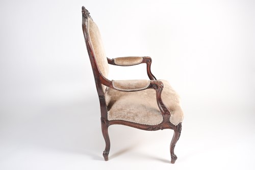 Lot 259 - A French Louis XV style carved walnut fauteuil...