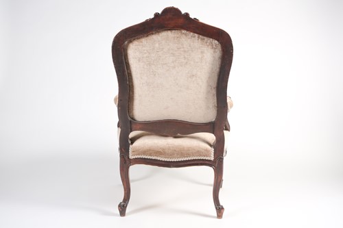Lot 259 - A French Louis XV style carved walnut fauteuil...
