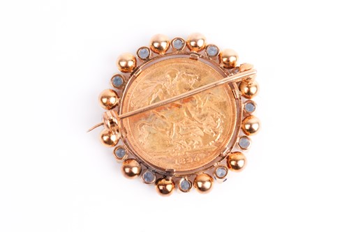 Lot 8 - A yellow metal mounted sovereign brooch, set...