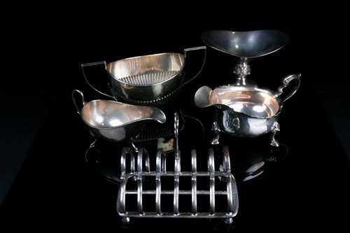 Lot 537 - A silver toast rack, London 1896, together...