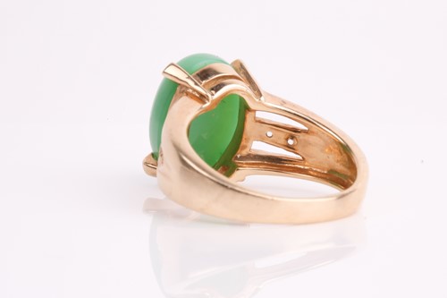 Lot 108 - A jade and diamond ring, the oval jade...