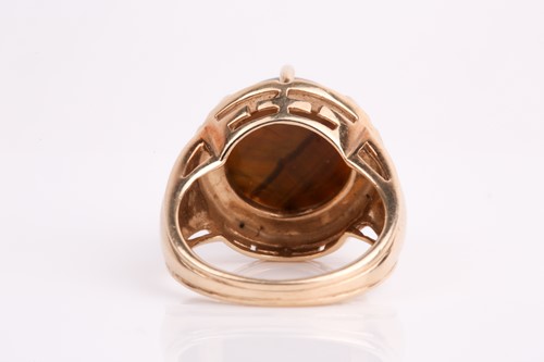 Lot 292 - A single stone tiger's eye dress ring, the...