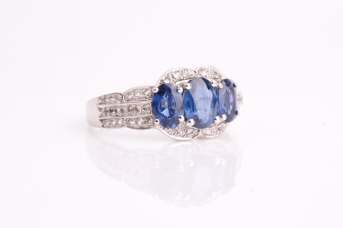 Lot 227 - A sapphire and diamond three stone cluster...
