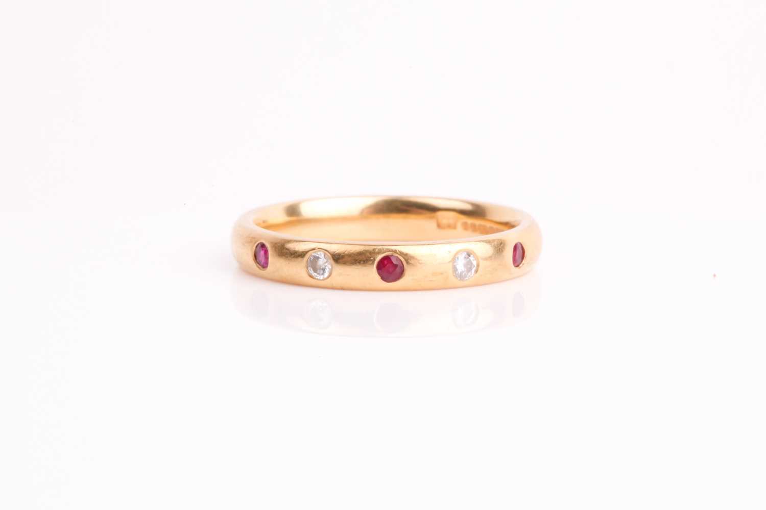 Lot 212 - A diamond and ruby half eternity ring, the...