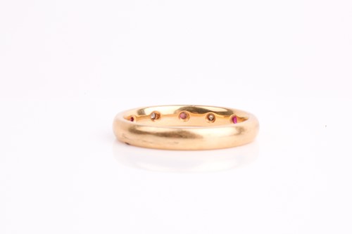 Lot 212 - A diamond and ruby half eternity ring, the...