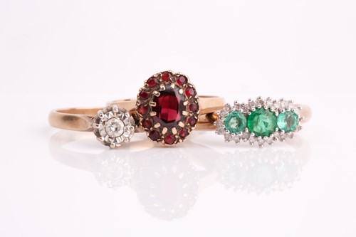 Lot 376 - An emerald and diamond triple cluster ring, a...