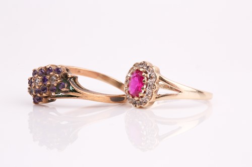 Lot 189 - A ruby and diamond oval cluster ring together...