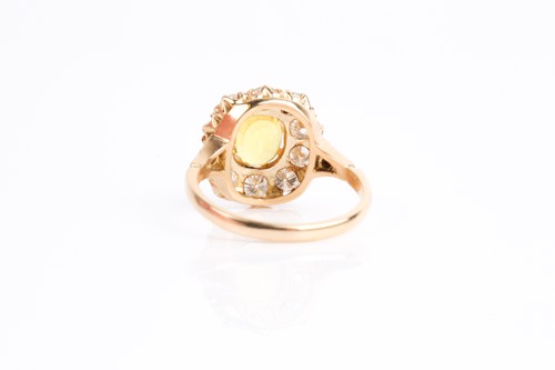 Lot 68 - A yellow sapphire and diamond cluster ring,...