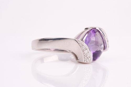 Lot 194 - A 9ct white gold, diamond, and amethyst ring,...