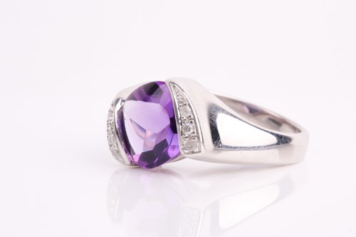 Lot 194 - A 9ct white gold, diamond, and amethyst ring,...