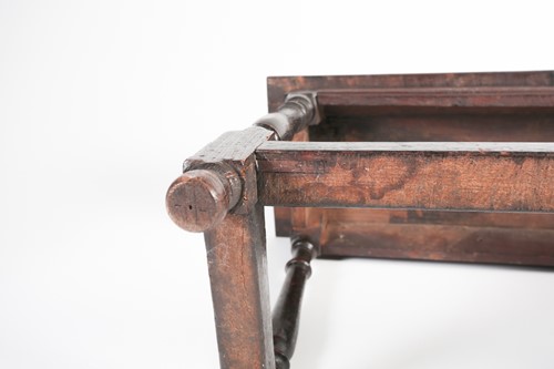 Lot 131 - A part 17th century oak long stool with 'thumb'...