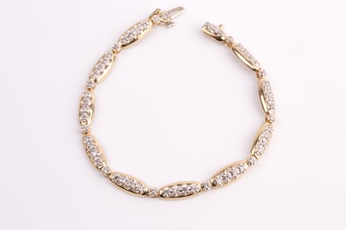 Lot 321 - A yellow metal and diamond bracelet, the...