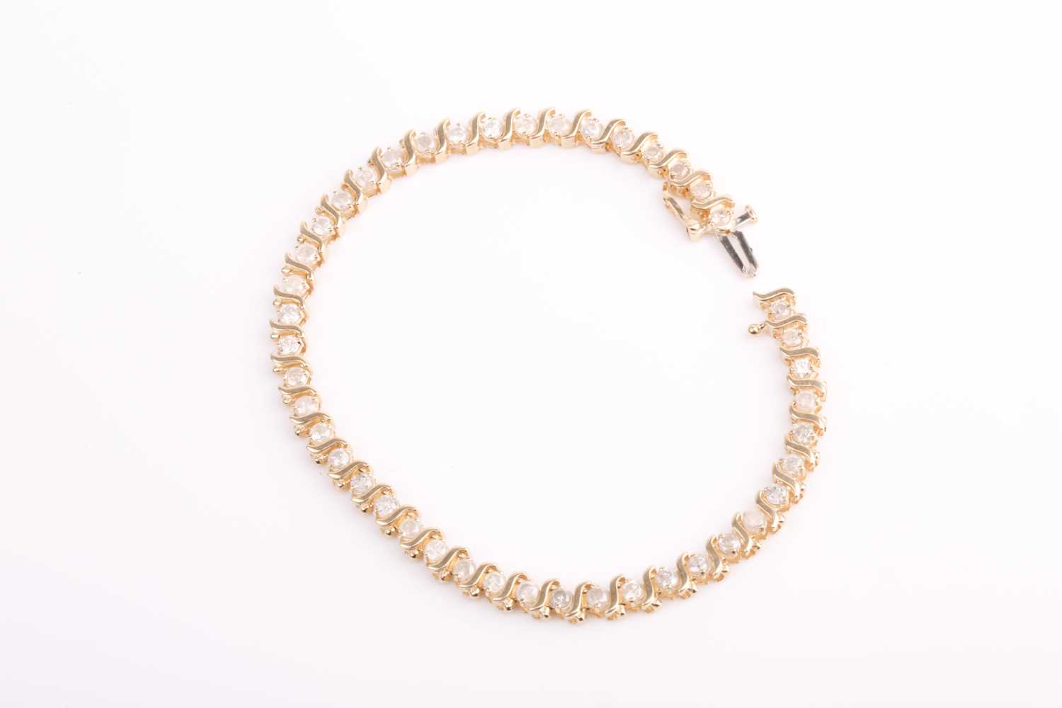 Lot 66 - A yellow gold and diamond bracelet, set with...