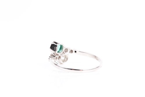 Lot 16 - An emerald and diamond crossover ring, with...