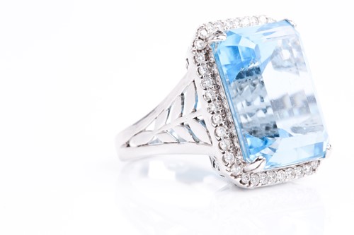 Lot 366 - A blue topaz and diamond dress ring, the...