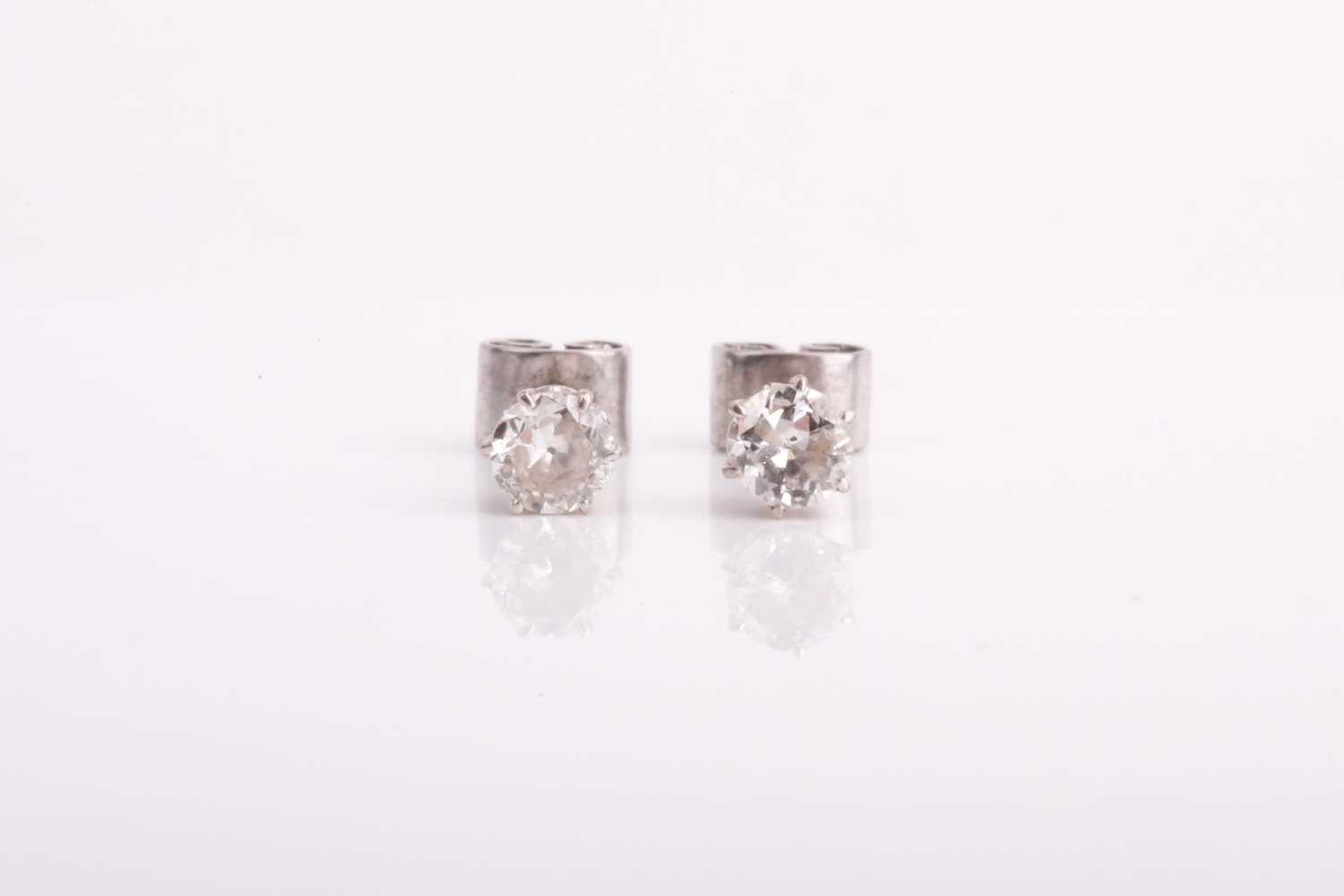 Lot 293 - A pair of solitaire diamond earrings of...