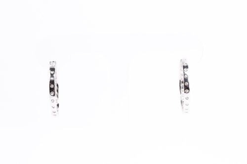 Lot 54 - A fine pair of diamond earrings, each set with...