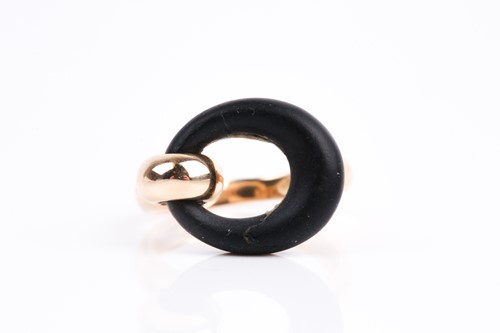 Lot 343 - A yellow metal and black stone ring, in the...