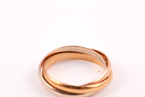 Lot 51 - A Cartier 'Trinity' three colour gold ring; in...