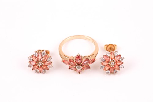 Lot 89 - An orange and white sapphire cluster ring, the...