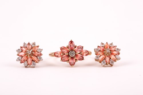 Lot 89 - An orange and white sapphire cluster ring, the...