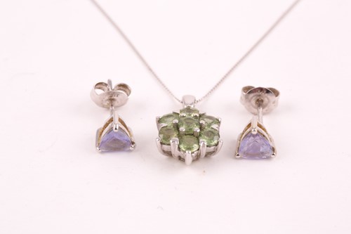 Lot 234 - A 9ct white gold and green sapphire seven...