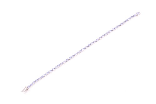 Lot 132 - An 18ct white gold and tanzanite line bracelet,...
