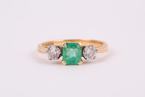 Lot 373 - An 18ct yellow gold, diamond, and emerald ring,...