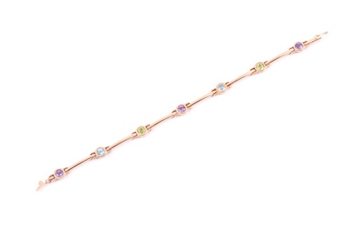 Lot 404 - A 9ct yellow gold and multi-gem bracelet, set...