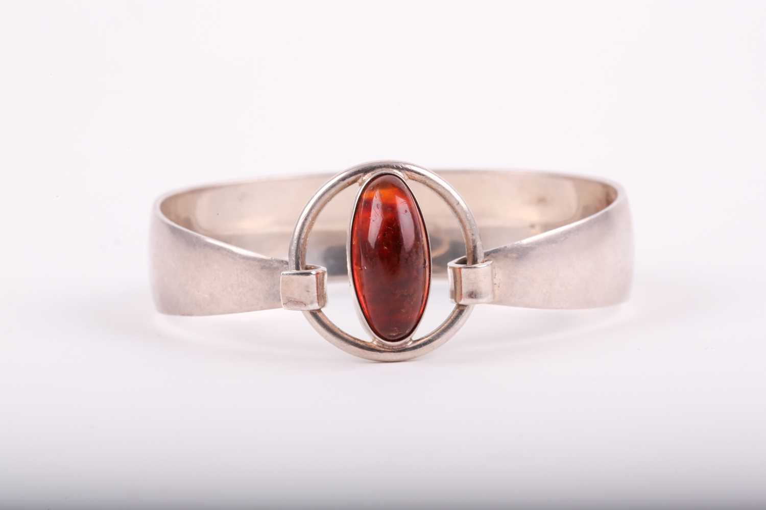 Lot 351 - A Danish sterling silver and amber bangle, by...