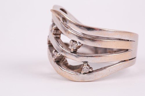 Lot 76 - A white gold and diamond swept band ring, the...