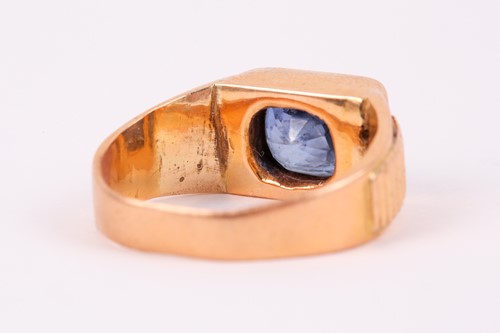 Lot 27 - A yellow metal and sapphire ring, set east to...