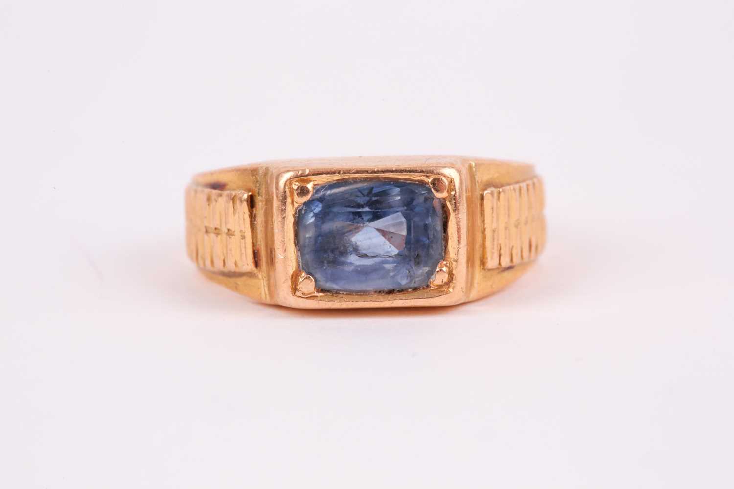 Lot 27 - A yellow metal and sapphire ring, set east to...