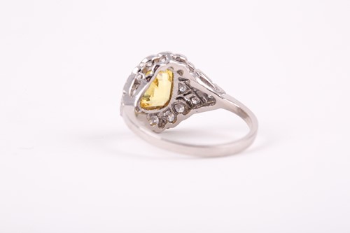 Lot 251 - A platinum, diamond, and yellow sapphire ring,...