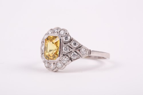 Lot 251 - A platinum, diamond, and yellow sapphire ring,...