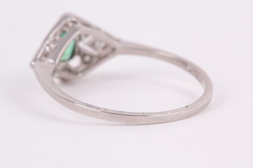Lot 186 - A platinum, diamond, and emerald ring, the...