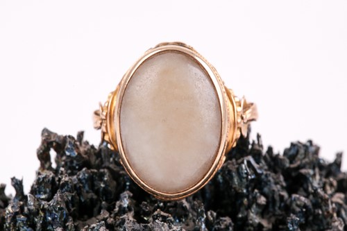 Lot 214 - An 18ct yellow gold and jade ring, set with an...