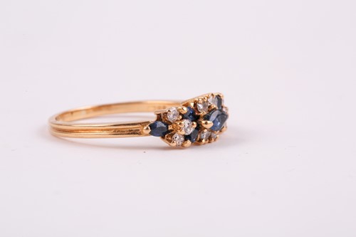Lot 174 - An 18ct yellow gold, diamond, and sapphire...