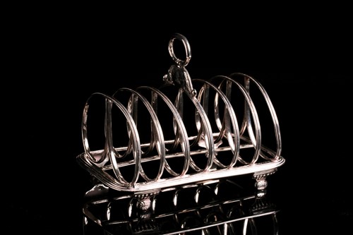 Lot 556 - A George III silver toastrack, London 1818 by...