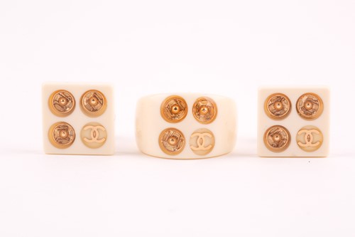 Lot 349 - Chanel. A cream plastic ring inset with the...