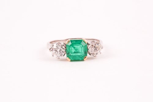Lot 278 - An emerald and diamond three stone half hoop...