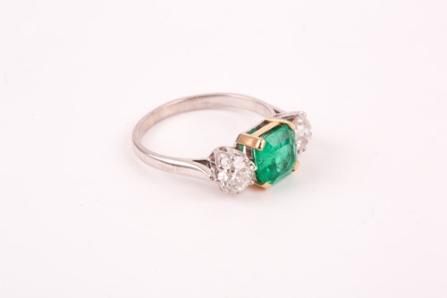 Lot 278 - An emerald and diamond three stone half hoop...