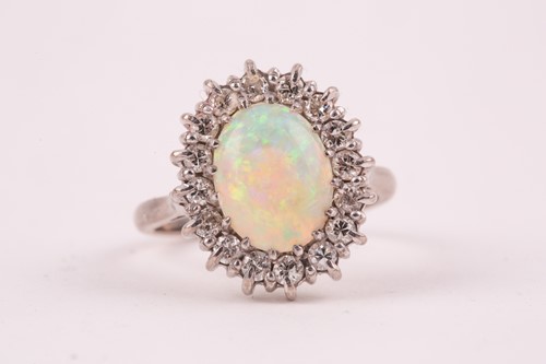 Lot 207 - An 18ct white gold, diamond, and opal cluster...