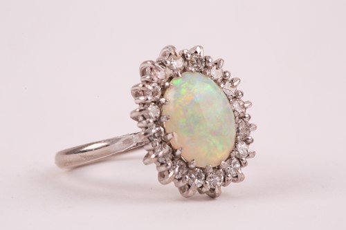 Lot 207 - An 18ct white gold, diamond, and opal cluster...