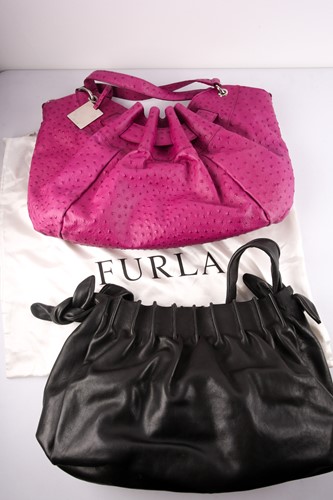 Lot 425 - A Furla pink leather handbag with removeable...