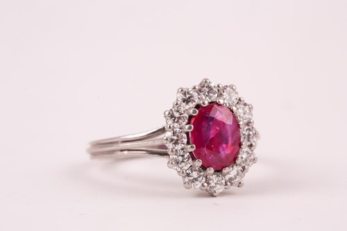Lot 9 - A ruby and diamond cluster ring, the oval...