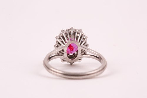 Lot 9 - A ruby and diamond cluster ring, the oval...