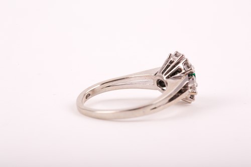 Lot 216 - An 18ct white gold, diamond, and emerald ring,...