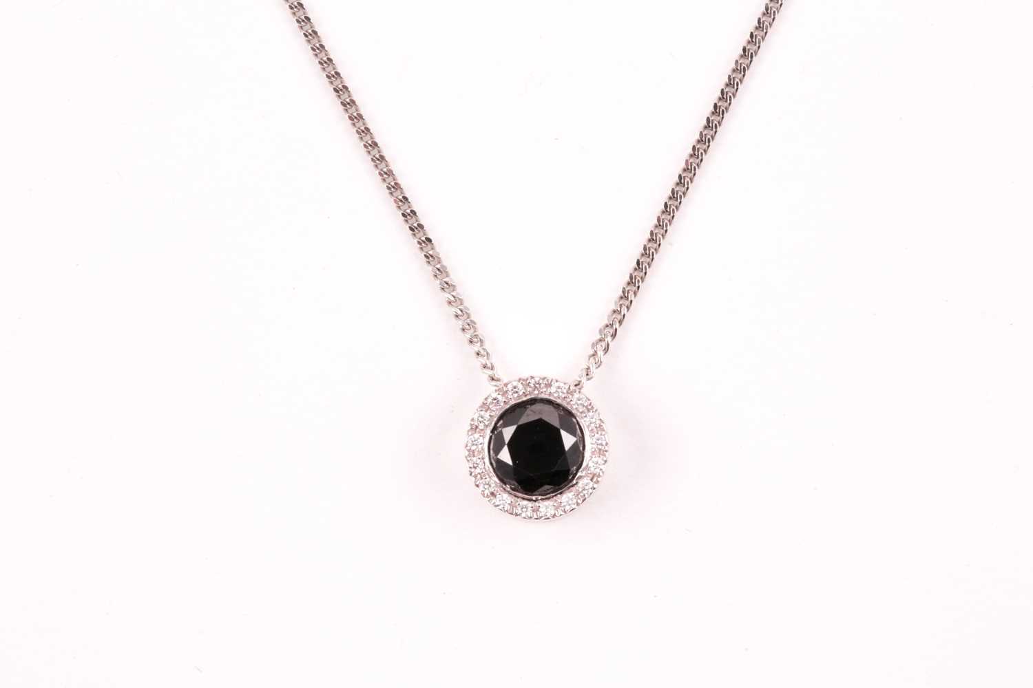 Lot 57 - An 18ct white gold and black diamond pendant,...